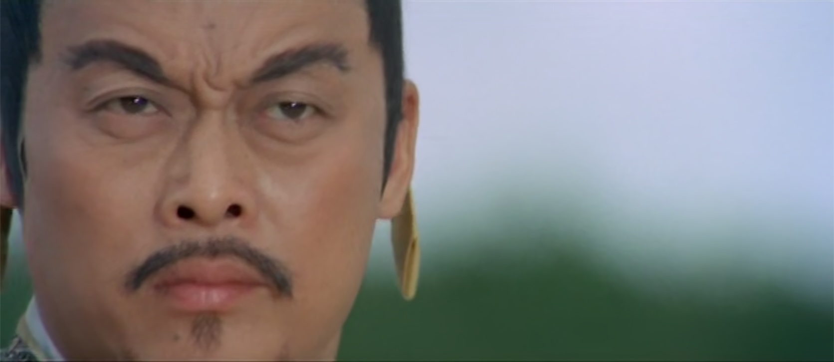 A close-up of Tieng Feng, framed on the far left side of the frame